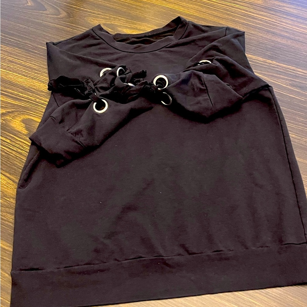 Black sweatshirt with silver loops and black ribbon down the sides.